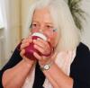 Woman drinking out of two handed mug